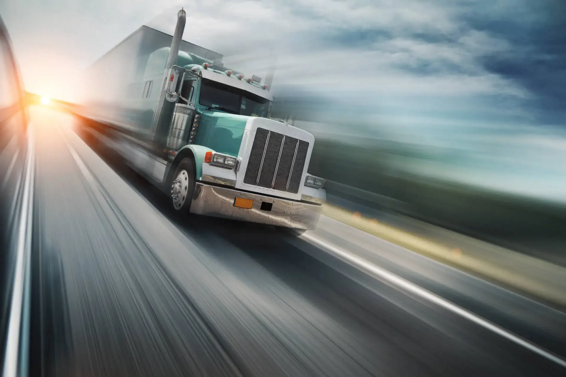 Semi truck driving down the road with the illusion of wind and speed behind it